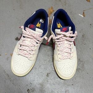 Nike Low-Top Sneakers in Cream with Navy & Red Details